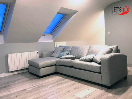 Grey attic with panelling wall